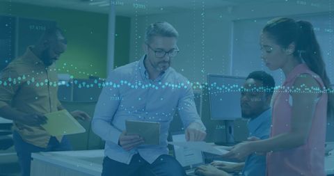 Diverse Professionals Collaborating on Financial Data in Modern Office