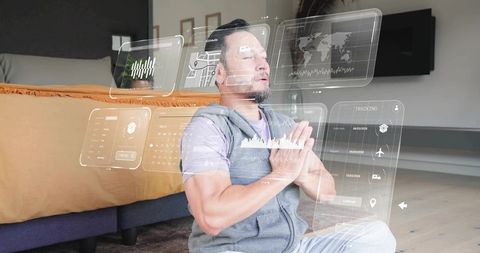 Asian man meditating with holographic wellness interface in minimalist bedroom at home