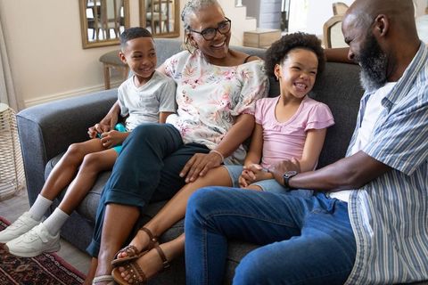 Multigenerational Family Sharing Happy Moment on Sofa