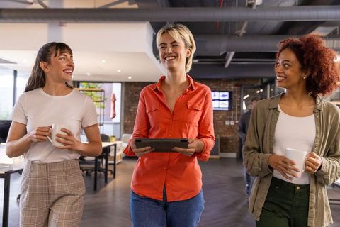 Diverse Coworkers Communicating in Modern Open-Plan Office