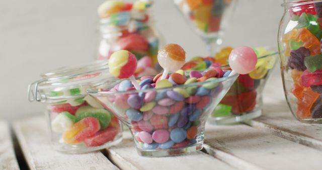 Colorful Varied Candies in Glass Bowls Placed on Wooden Table - Download Free Stock Images Pikwizard.com