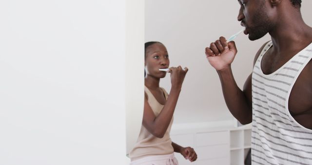 Young African American Couple Brushing Teeth Together in Modern Bathroom - Download Free Stock Images Pikwizard.com