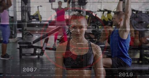 Focused athlete standing in gym with futuristic HUD overlay for fitness tech concept