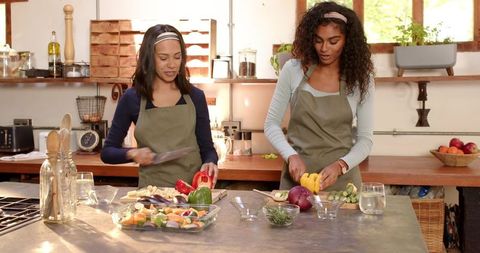 Friends in Rustic Kitchen Preparing Fresh Bell Peppers Together