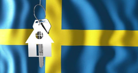 Hanging house key with swedish flag representing homeownership, property investment, mortgage