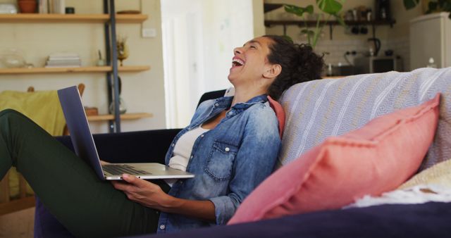 Smiling caucasian woman using laptop on image call, sitting on sofa at home - Download Free Stock Photos Pikwizard.com