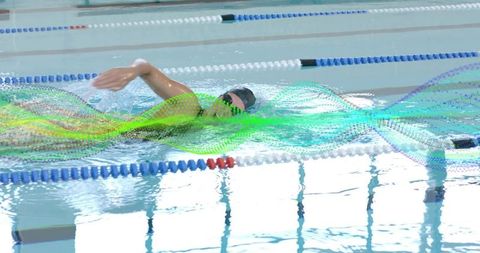 Female swimmer doing freestyle laps with colorful motion overlay in indoor pool