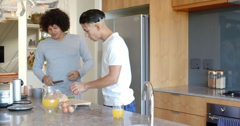 Diverse friends preparing breakfast in modern kitchen