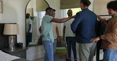 Groom and Groomsmen Choosing Wedding Attire in Cozy Home