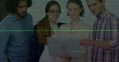 Diverse Team Analyzing Data on Laptop in Office Setting