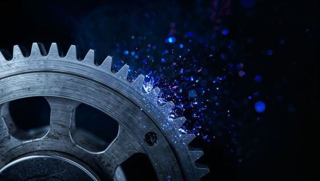 Sparking steel gear emitting blue-purple neon sparks with metal shavings, industrial macro