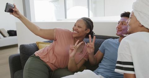 Friends Enjoying Playful Beauty Session at Home Taking Selfie