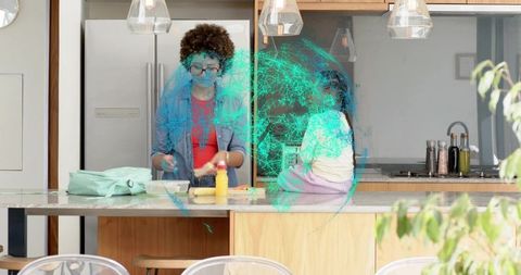 Mother and daughter preparing snack at kitchen island with teal digital network overlay
