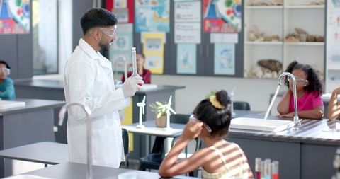 Science Teacher Guiding Diverse Students in Lab Experiment