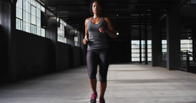 Focused Athlete Running Indoors in Urban Industrial Environment - Download Free Stock Images Pikwizard.com