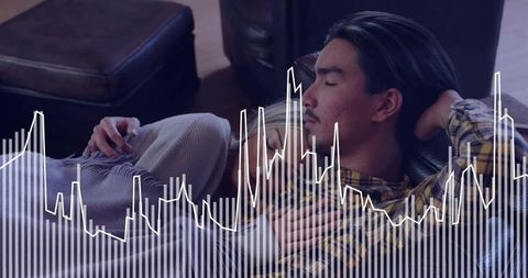 Young couple reclining and cuddling on leather sofa with waveform overlay for media