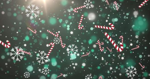 Candy canes and snowflakes falling on green background
