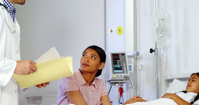 Concerned Mother with Child in Hospital and Doctor Holding Medical Records - Download Free Stock Images Pikwizard.com