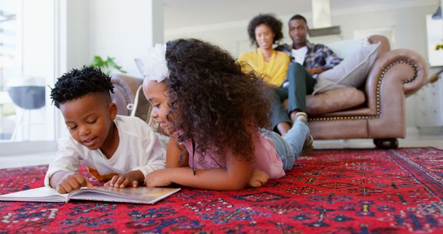Front view of cute black kids reading story book in living room comfortable home. Mother and father relaxing on the couch 4k