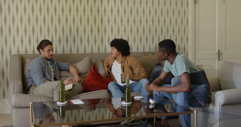 Friends Enjoying Casual Get-Together on Comfortable Sofa at Home