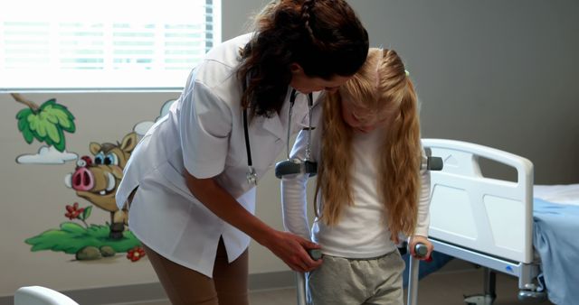 Female Doctor Assisting Child with Crutches in Hospital Room - Download Free Stock Images Pikwizard.com