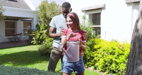 Couple Enjoying Gardening in Sunlit Suburban Backyard Retreat
