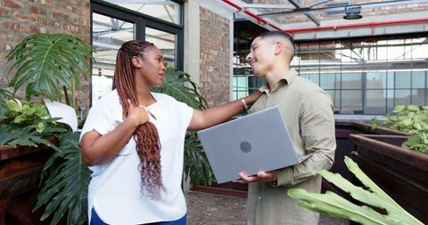 Colleagues Collaborating in Open Office Environment