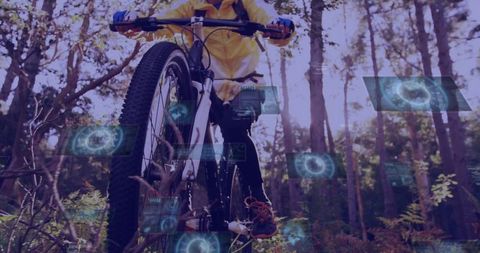 Mountain biker in yellow jacket riding forest singletrack with augmented HUD overlays