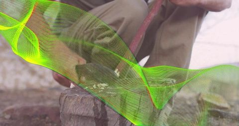 Man Chopping Wood with Red-Handled Hatchet Outdoors
