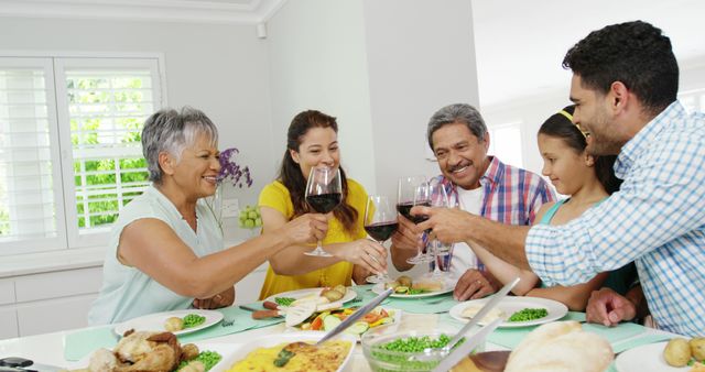 Happy Multigenerational Family Enjoying Meal and Toasting with Wine - Download Free Stock Images Pikwizard.com