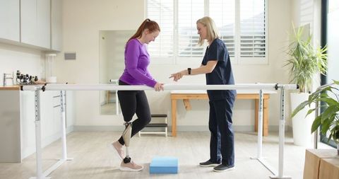 Physiotherapist Assisting Prosthetic Leg Wearer with Walking