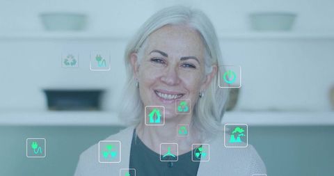 Smiling mature woman in kitchen with floating green energy icons promoting sustainability