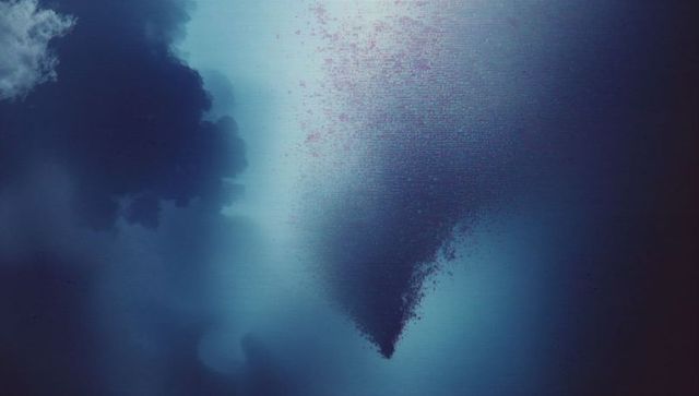 Massive swirling fish school in deep ocean