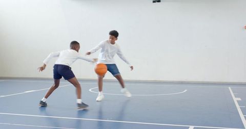 Boys Playing Basketball in Indoor Gym Pursuing Agile Dodges