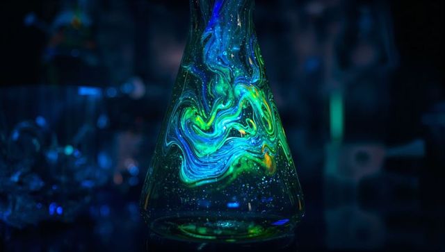 Glowing Conical Flask Swirling Teal Liquid with Neon Nebula Effect and Bokeh Reflections