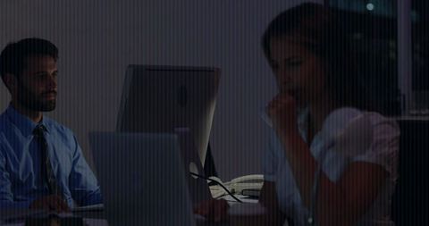 Coworkers working late at night office