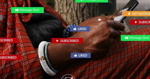 Mature man holding smartphone and scrolling, wearing beaded bracelets and red plaid wrap