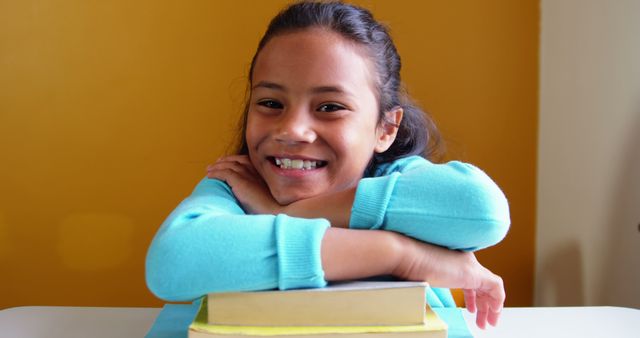 Smiling Girl Leaning on Stack of Books - Download Free Stock Images Pikwizard.com