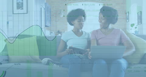 Mother and Daughter Analyzing Stock Market Data on Laptop