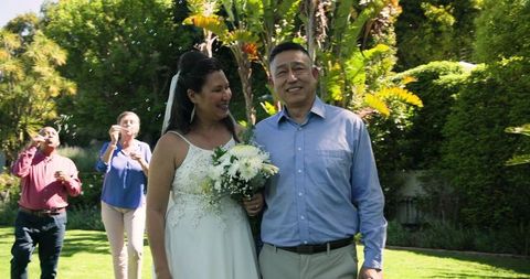Smiling Bride and Groom Enjoying Outdoor Wedding Ceremony