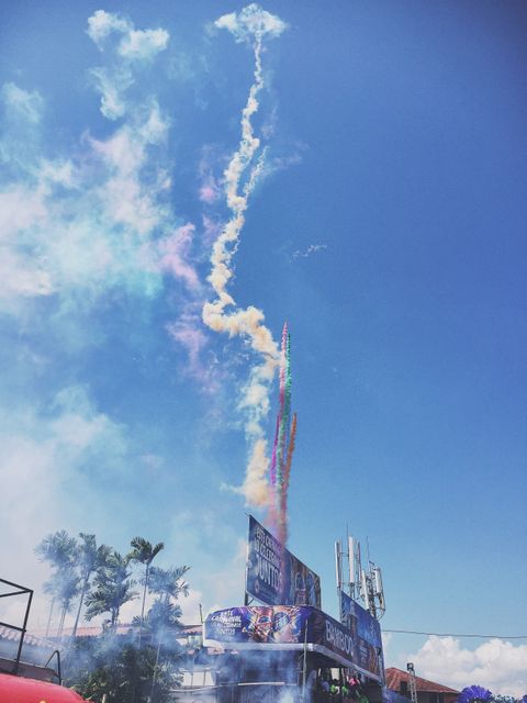 Colorful Smoke Trails Rising in Bright Blue Sky at Outdoor Event - Download Free Stock Photos Pikwizard.com