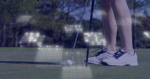 Golfer aiming putter behind ball on green with digital data overlay for sports technology