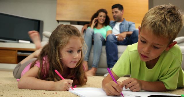 Children Drawing on Floor with Parents Relaxing on Sofa - Download Free Stock Images Pikwizard.com