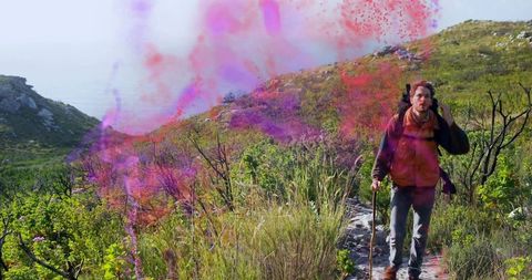 Hiking man with backpack amidst vibrant powder in wilderness