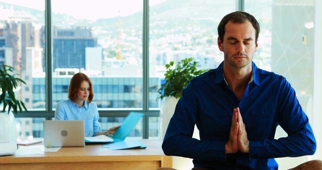 Businessman Practicing Meditation and Calmness in Modern Office - Download Free Stock Images Pikwizard.com