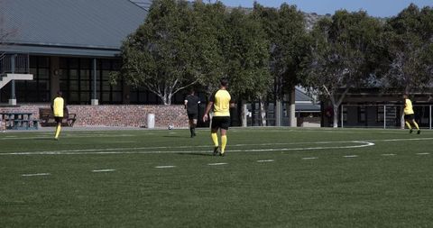 Teen Soccer Players Practicing Teamwork and Passing Skills on Field