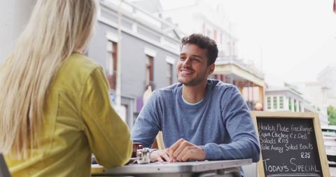 Couple Enjoying Coffee and Conversation on Urban Cafe Terrace