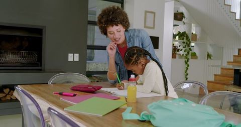 Mother Assisting Daughter with Homework in Cozy Modern Home