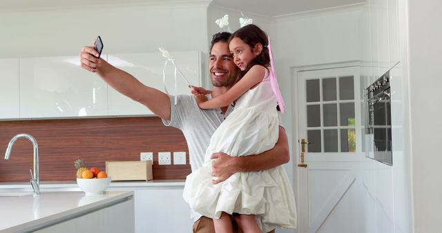 Father Holding Daughter Taking Selfie in Sunny Kitchen - Download Free Stock Images Pikwizard.com