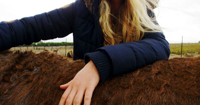 Woman Petting Animal Outdoors in Cold Weather - Download Free Stock Images Pikwizard.com